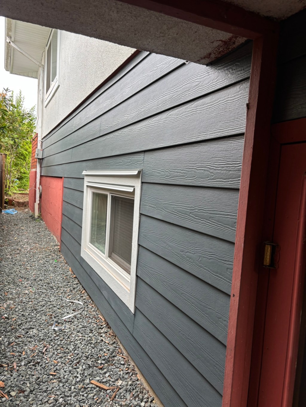 Hardie planks in Evening blue. Arctic white corners and trims. Custom head flashings and white mounting blocks. Vinyl perforated soffits.
